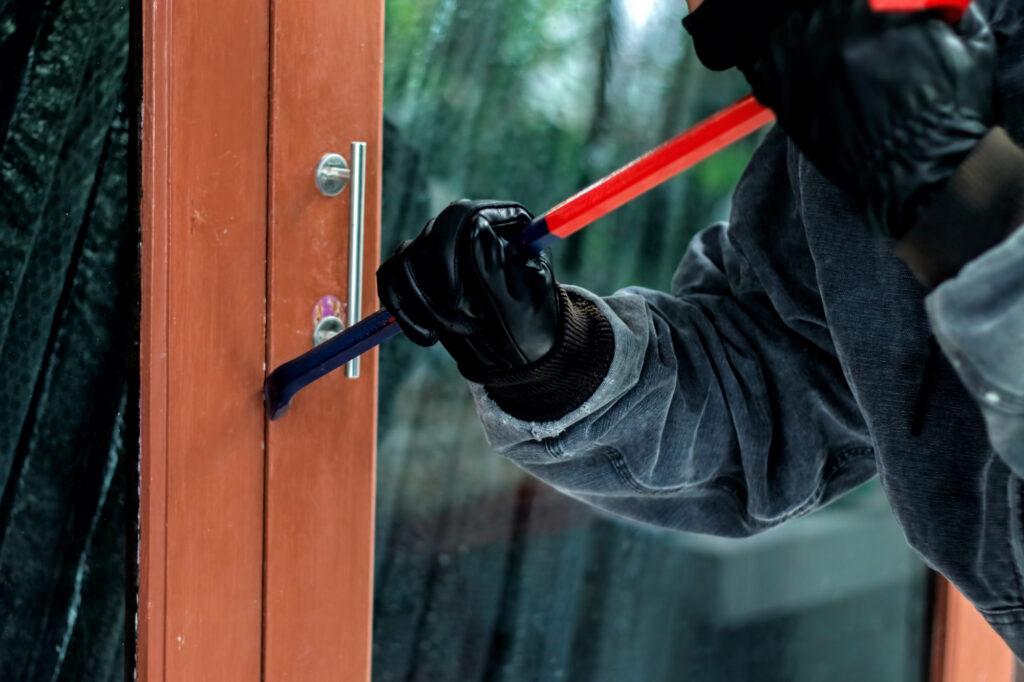 burglar-with-crowbar-trying-break-door-enter-house